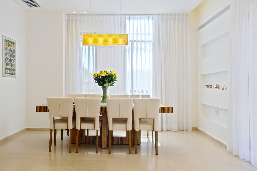 Modern dining room in Miami with white walls.