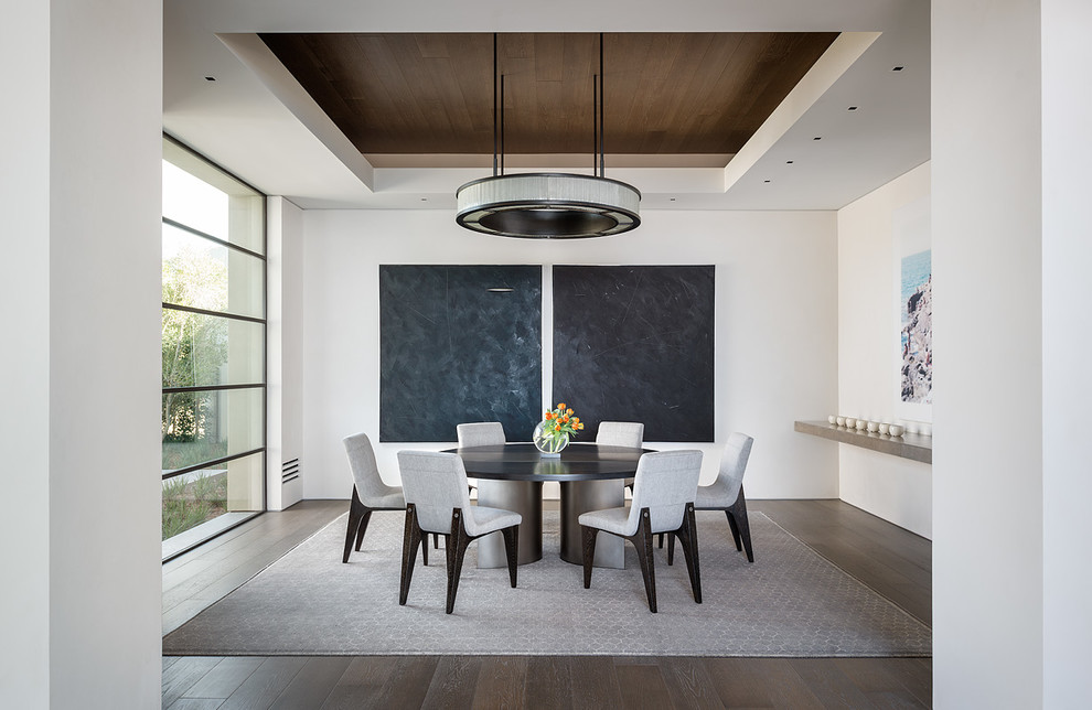 Inspiration for a contemporary dining room in San Diego with white walls and dark hardwood flooring.