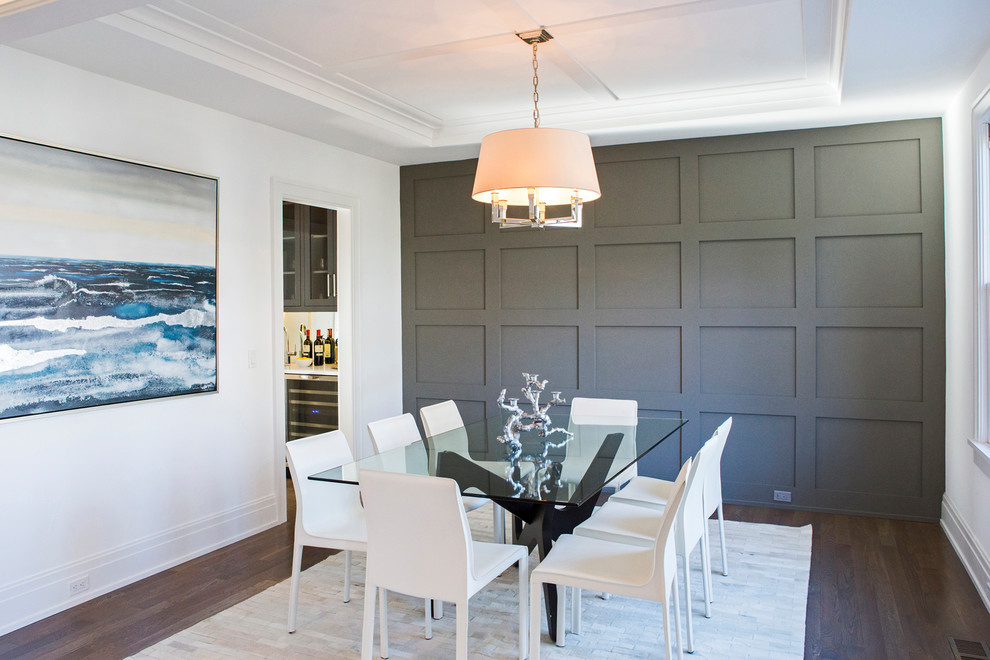Example of a transitional dark wood floor and brown floor enclosed dining room design in New York with white walls