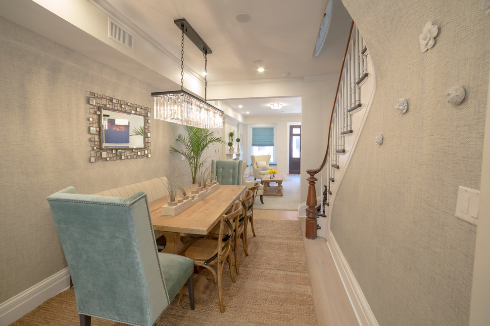 На фото: кухня-столовая среднего размера в стиле неоклассика (современная классика) с серыми стенами, светлым паркетным полом, стандартным камином, фасадом камина из плитки и бежевым полом