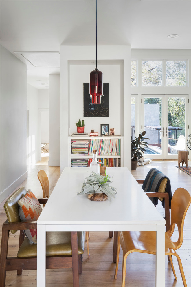 Design ideas for a medium sized scandi open plan dining room in Austin with white walls, light hardwood flooring and no fireplace.