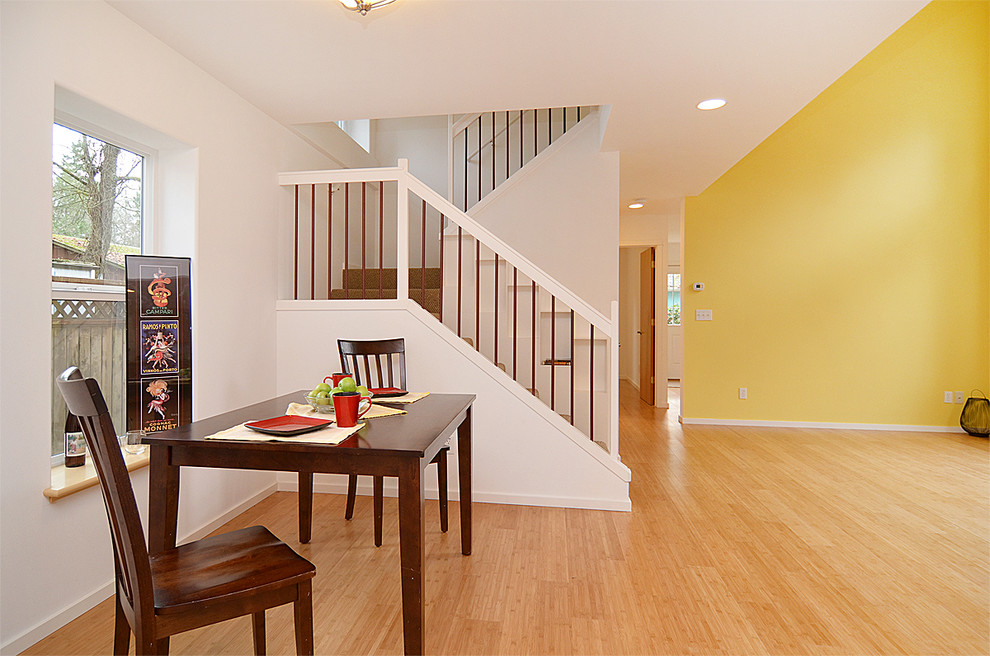 Medium sized classic open plan dining room in Seattle with bamboo flooring.