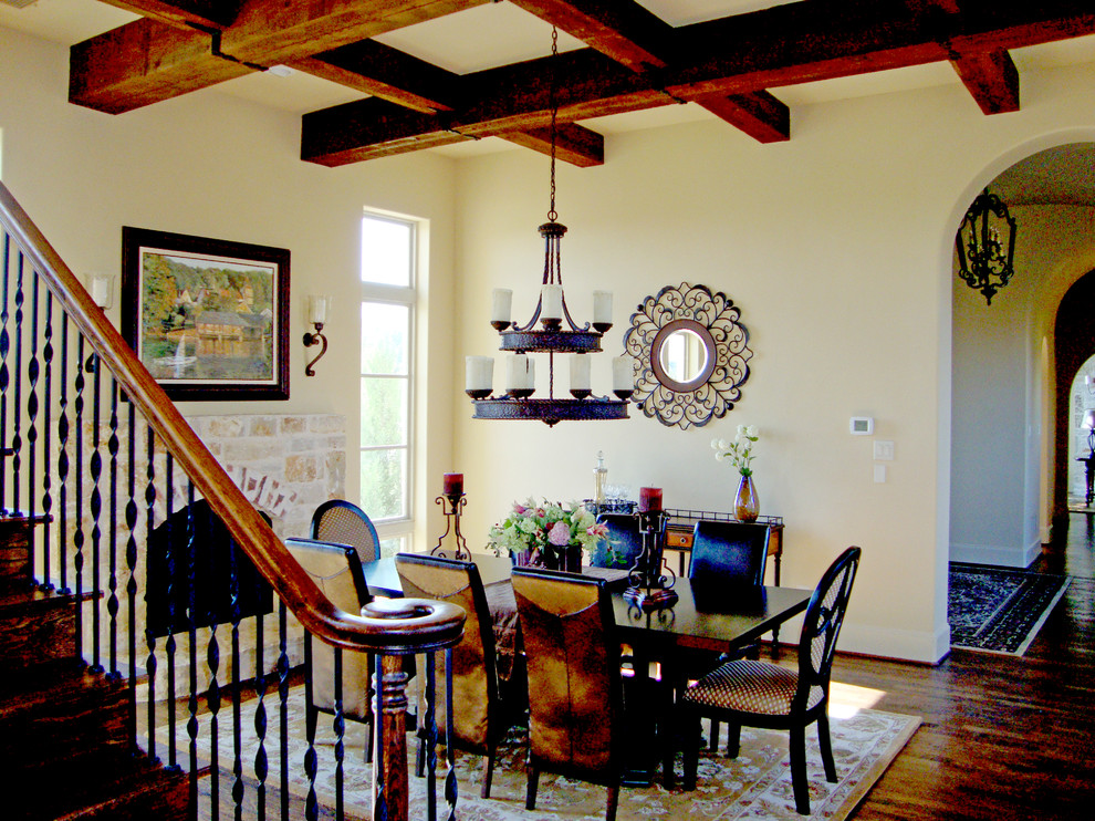 Large tuscan dark wood floor dining room photo in Dallas with beige walls, a standard fireplace and a stone fireplace