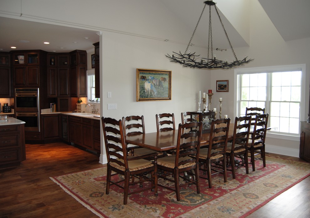 Immagine di una sala da pranzo aperta verso il soggiorno country con pareti grigie e pavimento in vinile