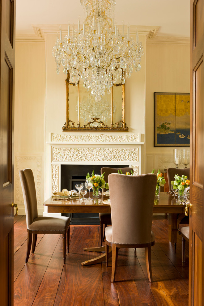 Classic dining room in DC Metro with beige walls, dark hardwood flooring and a standard fireplace.