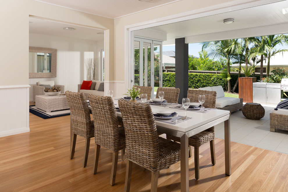 Inspiration for a coastal dining room in Sydney with beige walls, light hardwood flooring and beige floors.