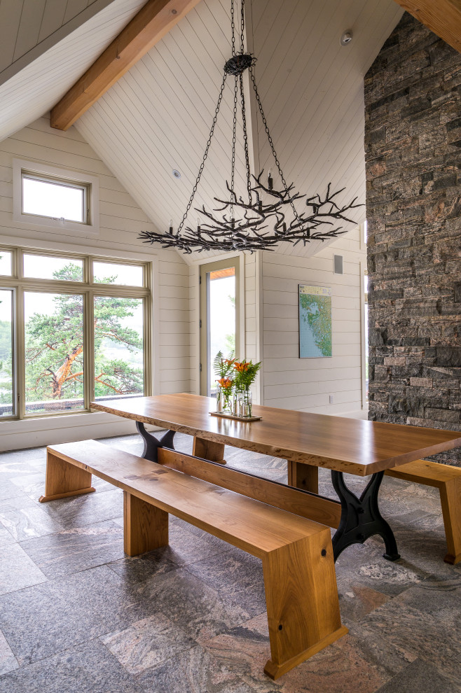 Photo of a large rural dining room in Toronto with white walls, grey floors and tongue and groove walls.