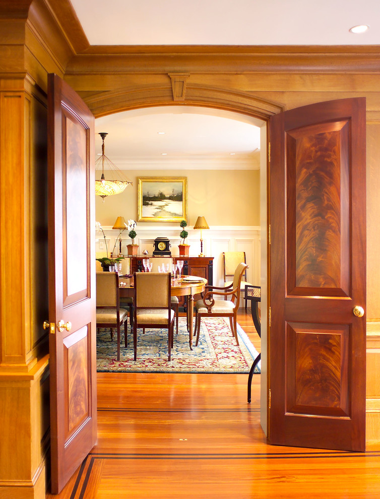 Classic enclosed dining room in Boston with beige walls and medium hardwood flooring.