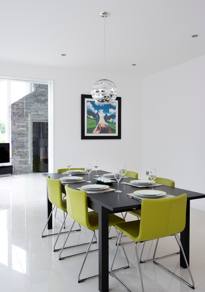 Example of a trendy kitchen/dining room combo design in Belfast with white walls and no fireplace