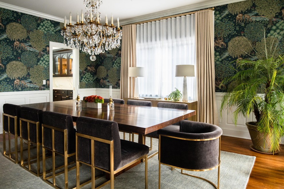Example of a large transitional medium tone wood floor and brown floor enclosed dining room design in Denver with multicolored walls