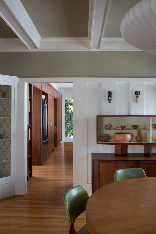 Ispirazione per una sala da pranzo aperta verso la cucina design di medie dimensioni con pareti bianche, pavimento in legno massello medio e nessun camino