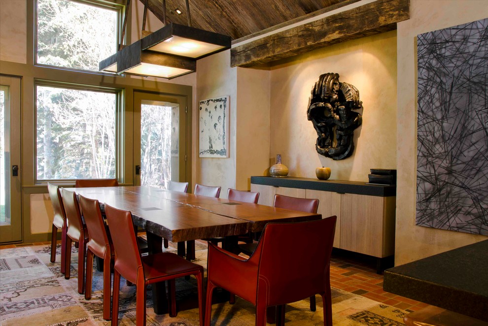 Inspiration for a contemporary dining room in Denver with beige walls and brick flooring.