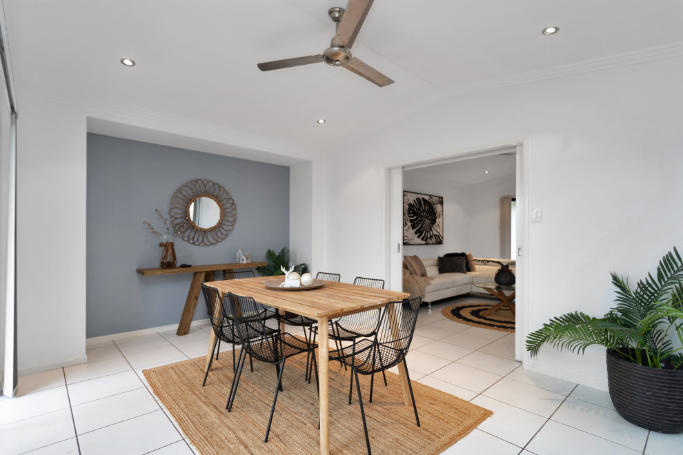 Example of a mid-sized trendy white floor enclosed dining room design in Other with white walls