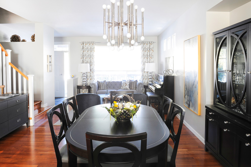 This is an example of a small contemporary dining room in Vancouver with grey walls, dark hardwood flooring and no fireplace.