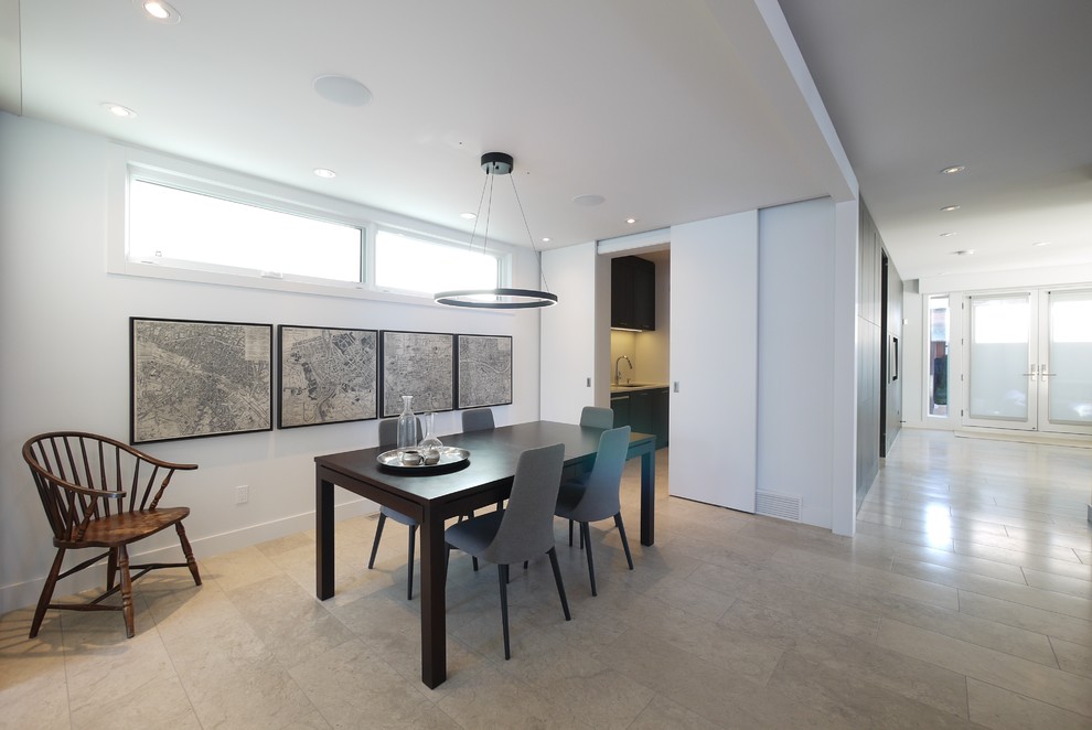 Inspiration for a large modern travertine floor enclosed dining room remodel in Calgary with white walls