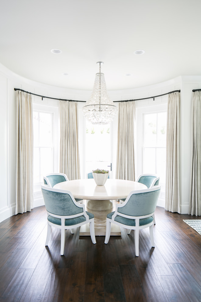 Beach style dining room in Orange County with white walls, dark hardwood flooring and brown floors.
