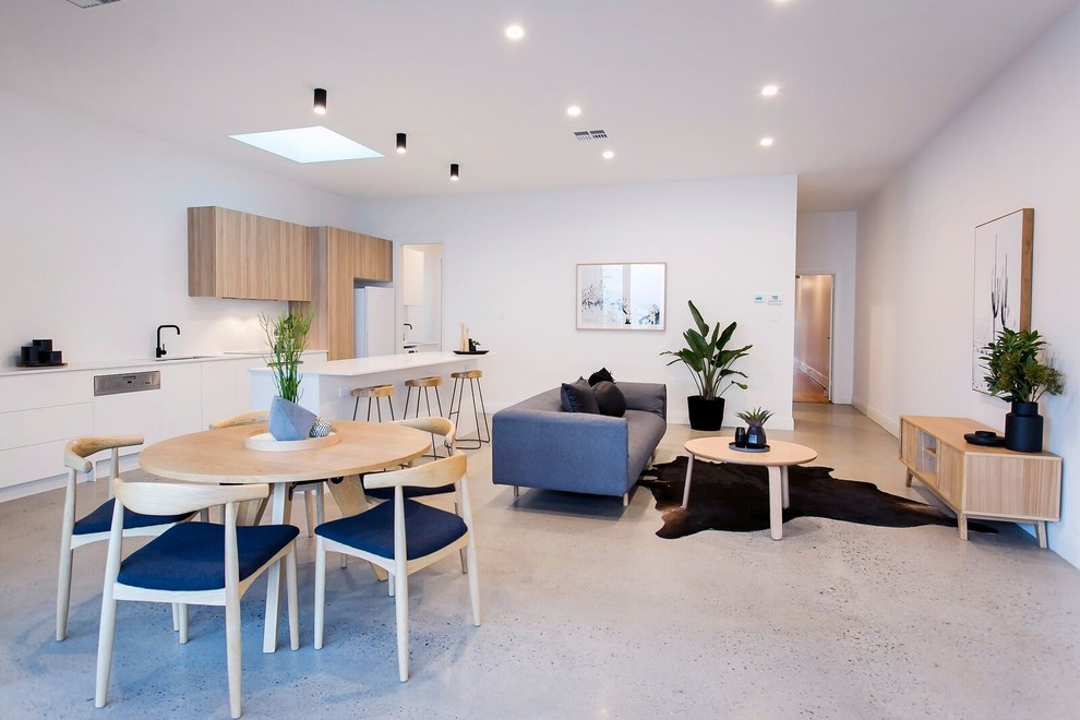 This is an example of a medium sized contemporary open plan dining room in Adelaide with white walls, concrete flooring and no fireplace.