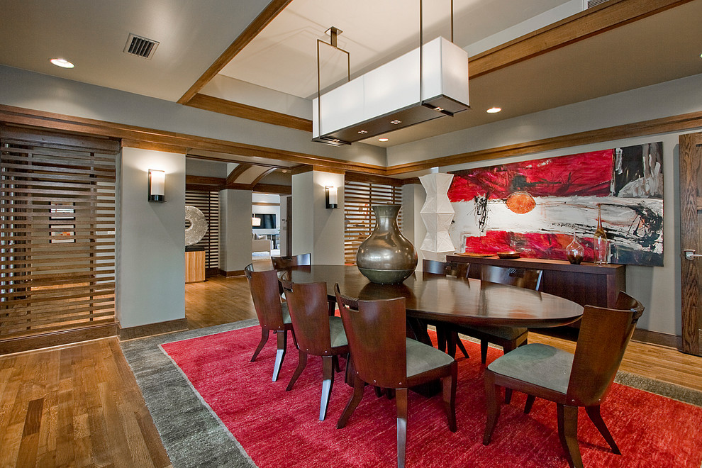 World-inspired dining room in Little Rock with grey walls, medium hardwood flooring and no fireplace.