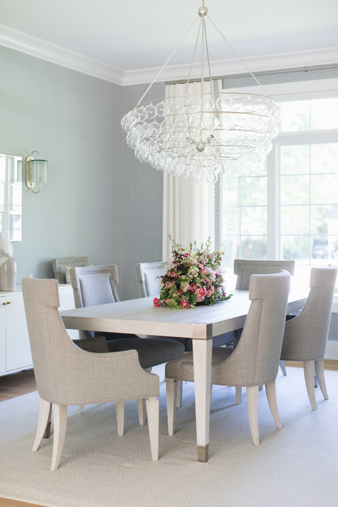 Design ideas for a coastal dining room in Chicago with grey walls and light hardwood flooring.