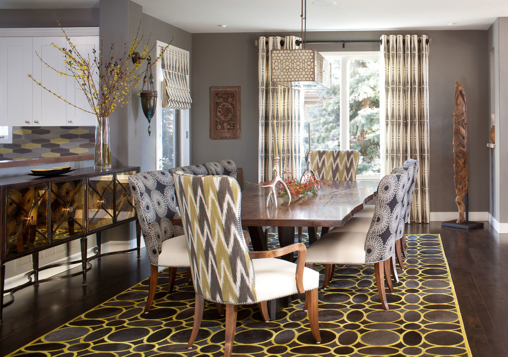 This is an example of an eclectic dining room in Denver.