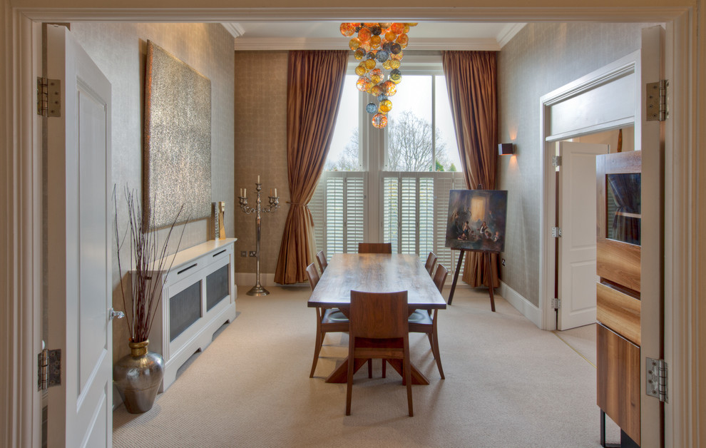Photo of a contemporary enclosed dining room in Manchester with beige walls and carpet.