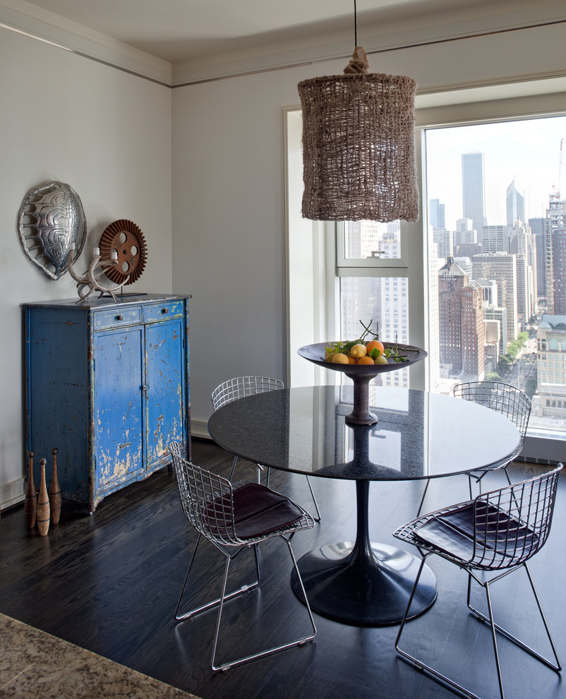 Photo of an eclectic dining room in Chicago with white walls and dark hardwood flooring.