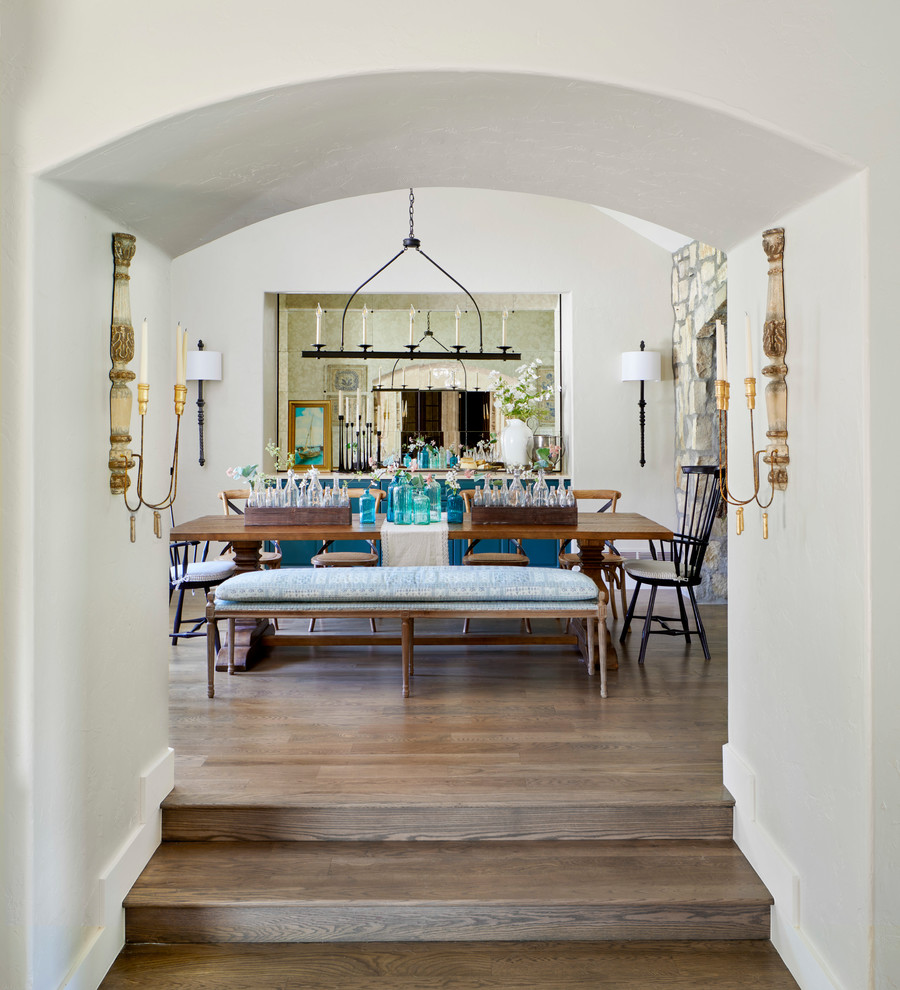 Idée de décoration pour une salle à manger ouverte sur la cuisine champêtre de taille moyenne avec un mur blanc, un sol en bois brun, aucune cheminée et un sol marron.