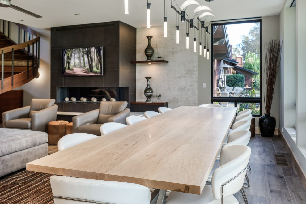 Photo of a large contemporary open plan dining room in Sacramento with white walls, porcelain flooring, beige floors and a tiled fireplace surround.