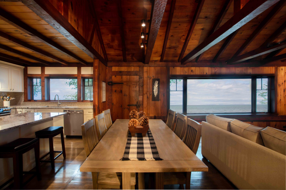 Inspiration for a medium sized rustic open plan dining room in Other with brown walls, medium hardwood flooring, brown floors, exposed beams and panelled walls.