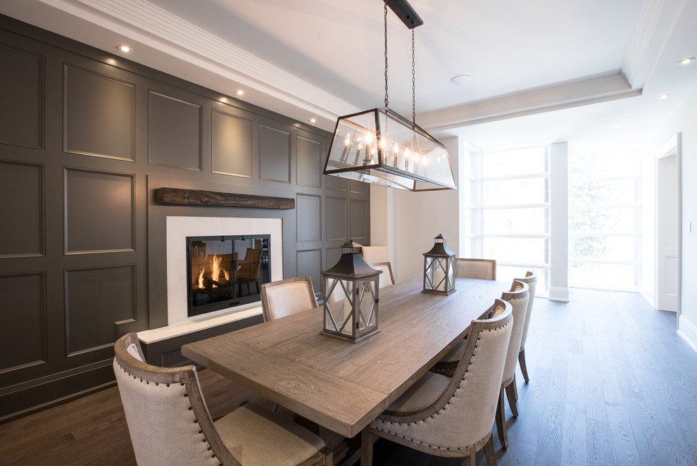 Design ideas for a classic dining room in Toronto with dark hardwood flooring, a standard fireplace and a stone fireplace surround.