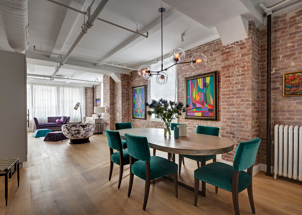 This is an example of an urban open plan dining room in New York with light hardwood flooring and no fireplace.