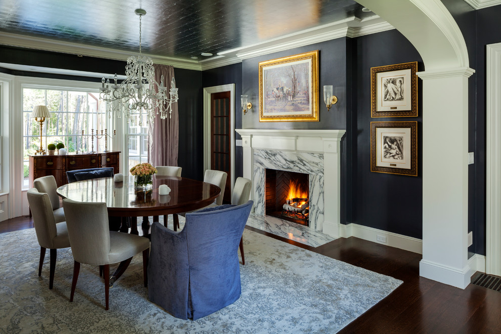 Example of a large classic dark wood floor dining room design in Boston with blue walls, a standard fireplace and a stone fireplace
