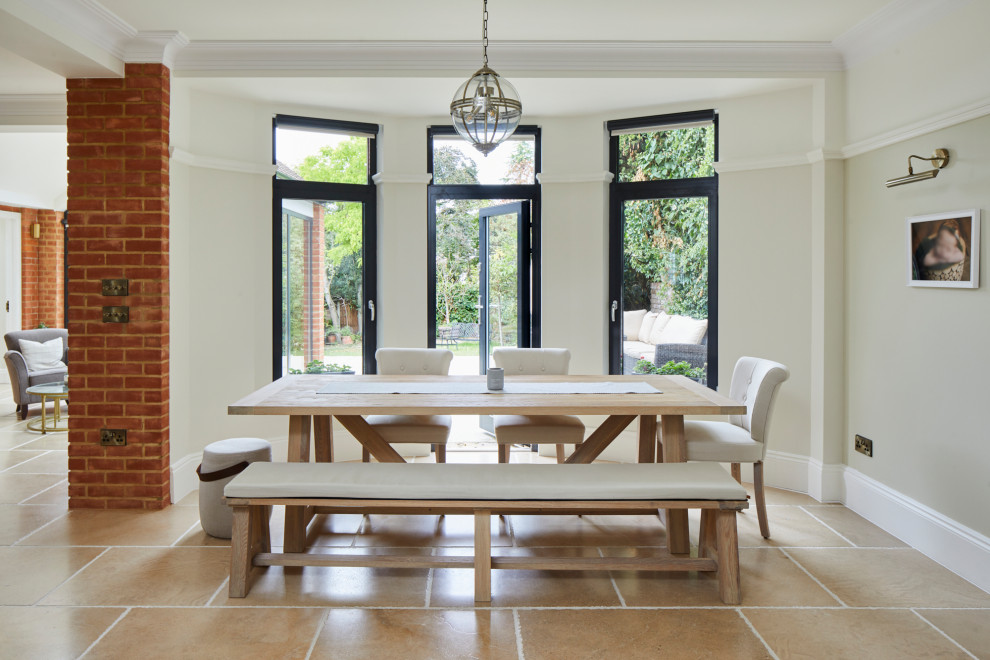 This is an example of a large classic dining room in London with grey walls, limestone flooring, a wood burning stove, a plastered fireplace surround, beige floors, a coffered ceiling, a feature wall and brick walls.