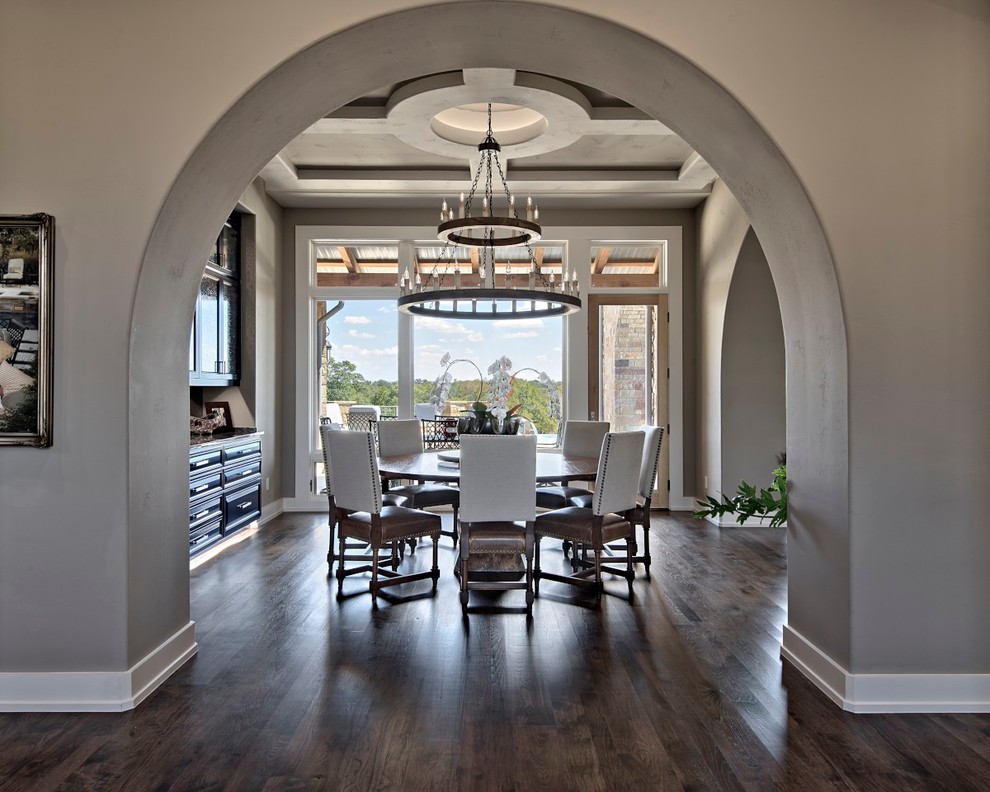 Example of a large transitional dark wood floor dining room design in Austin with beige walls