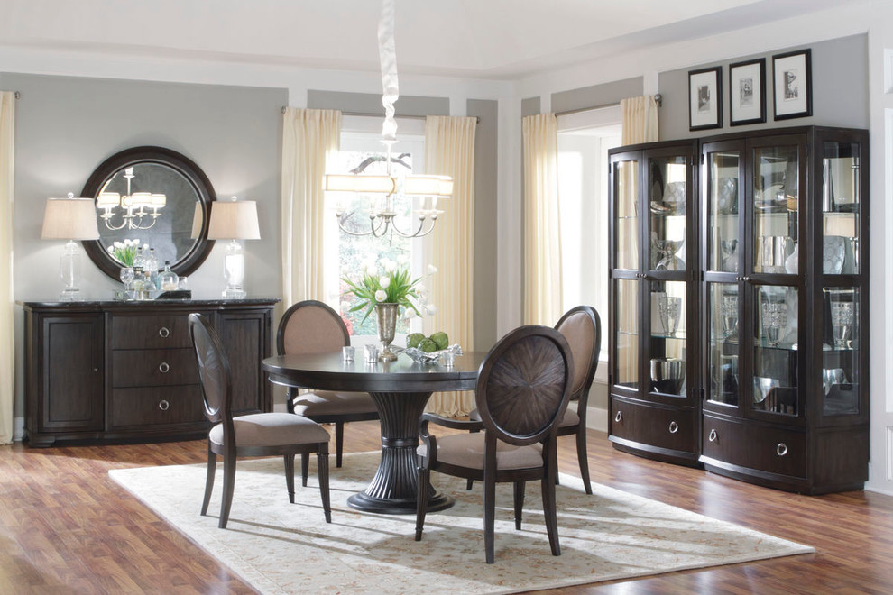 This is an example of a medium sized traditional open plan dining room in Charlotte with grey walls and medium hardwood flooring.