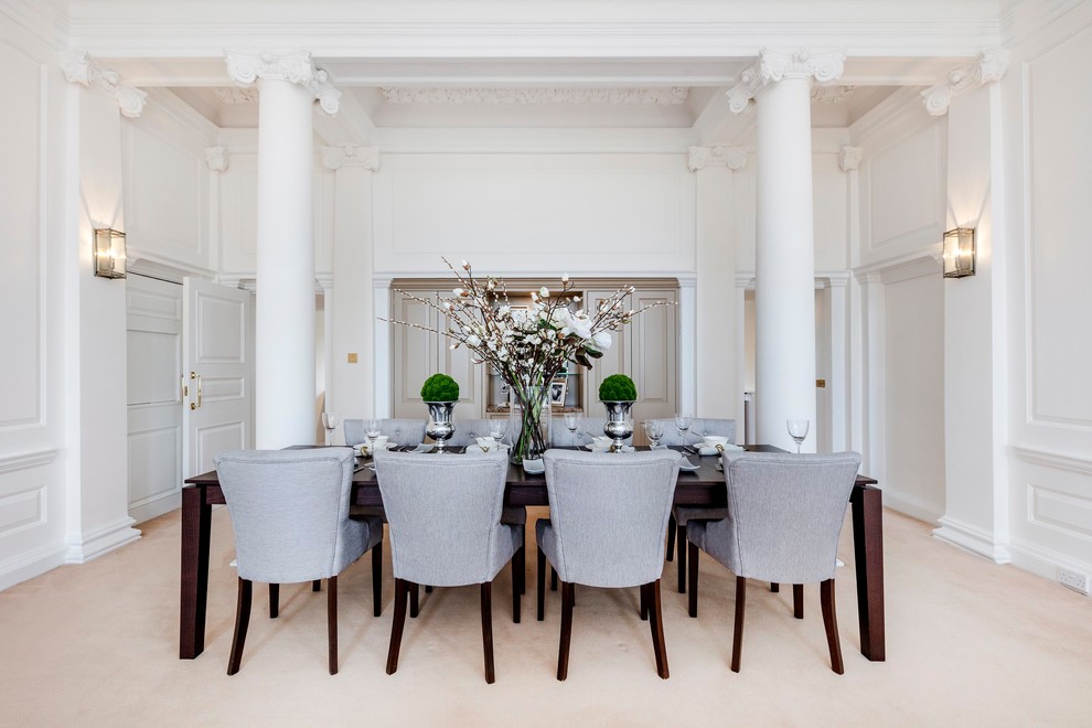 Traditional dining room in London with white walls, carpet and beige floors.