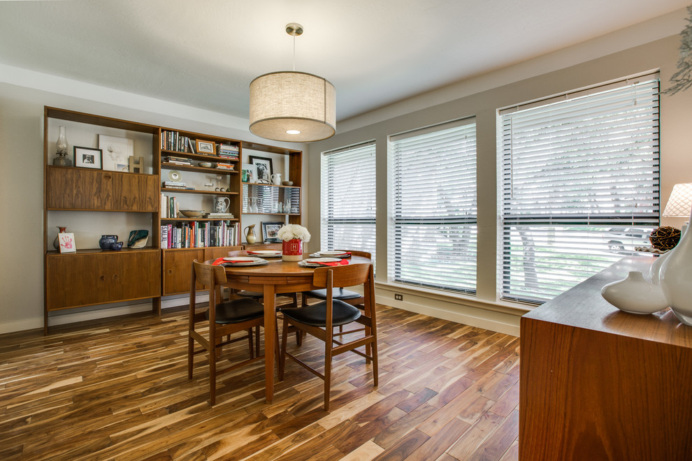 Example of a mid-sized trendy light wood floor enclosed dining room design in Austin with beige walls