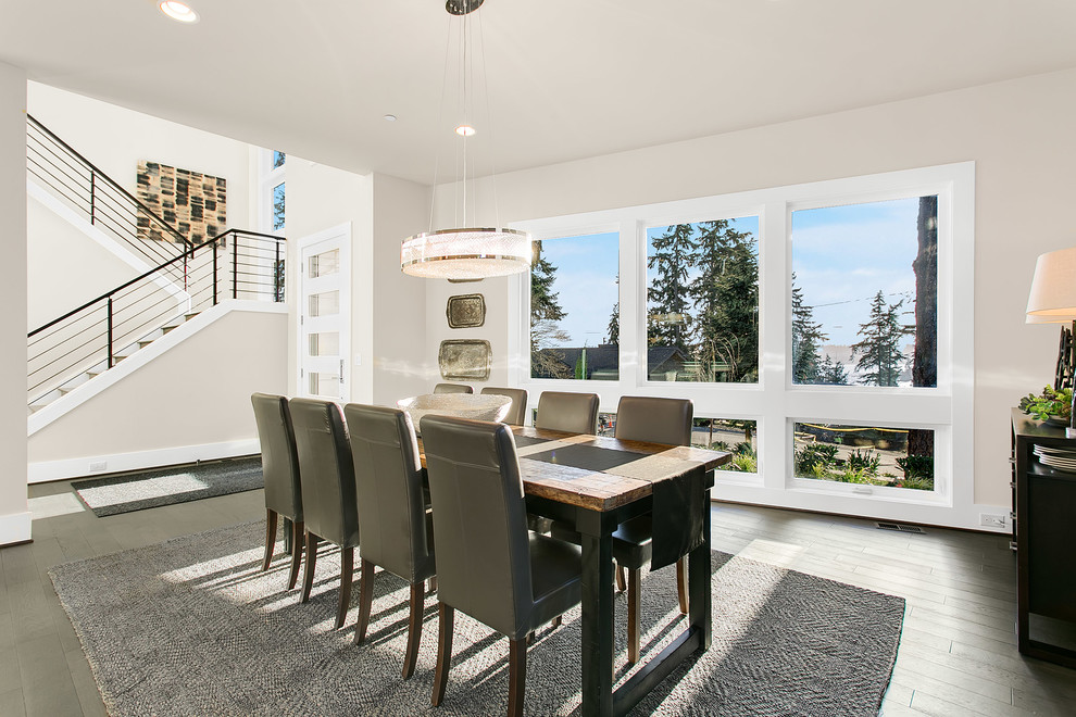 Large modern kitchen/dining room in Seattle with grey walls and medium hardwood flooring.