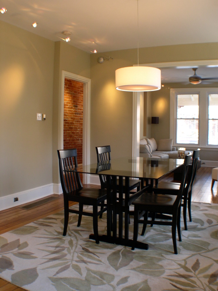Small classic open plan dining room in Philadelphia with beige walls and light hardwood flooring.