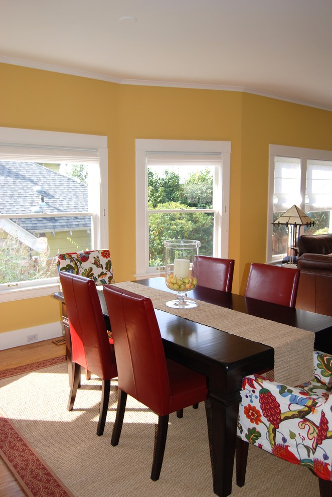 Example of a mid-sized classic light wood floor kitchen/dining room combo design in Seattle with yellow walls and no fireplace