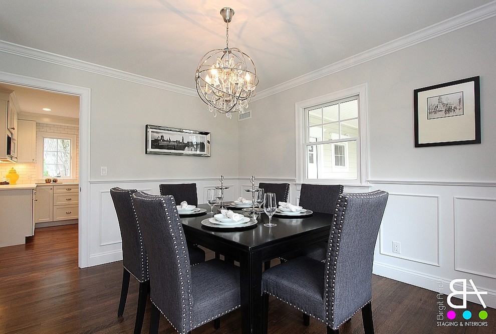 Photo of a small modern enclosed dining room in New York with dark hardwood flooring and grey walls.