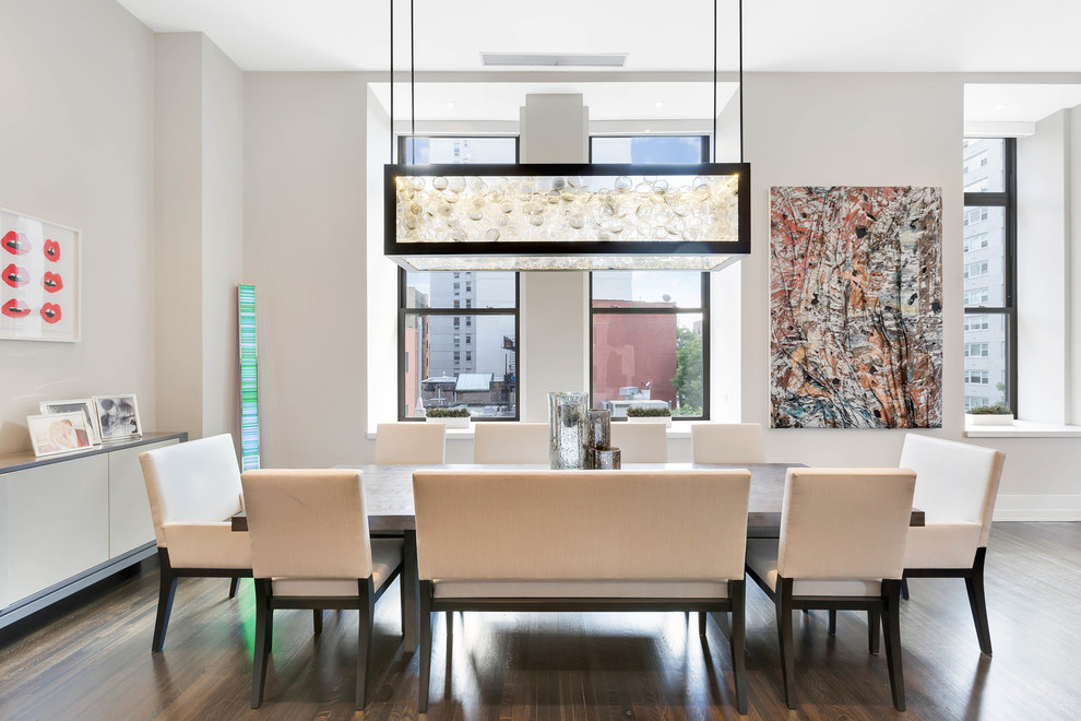 Example of a trendy dark wood floor and brown floor dining room design in New York with white walls