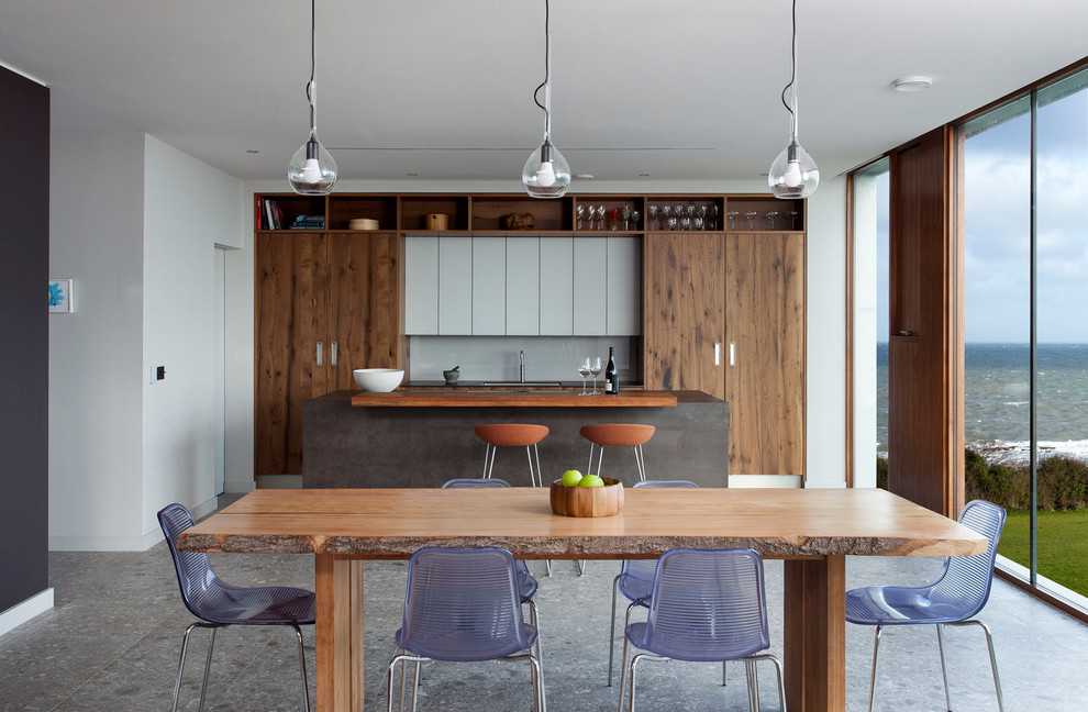 На фото: кухня-столовая среднего размера в современном стиле с белыми стенами и серым полом