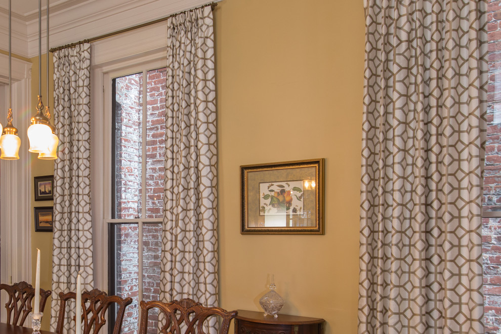 This is an example of a large traditional enclosed dining room in Richmond with yellow walls, medium hardwood flooring, a standard fireplace and a tiled fireplace surround.