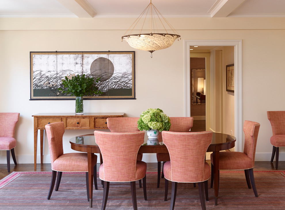 Elegant medium tone wood floor dining room photo in New York with beige walls