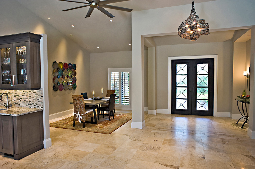 Cette photo montre une salle à manger ouverte sur la cuisine tendance de taille moyenne avec un mur beige, un sol en marbre et un sol beige.