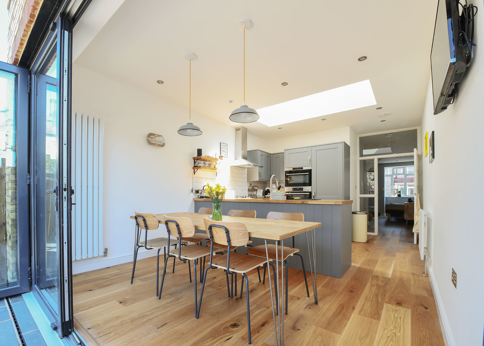 Medium sized contemporary kitchen/dining room in Surrey.