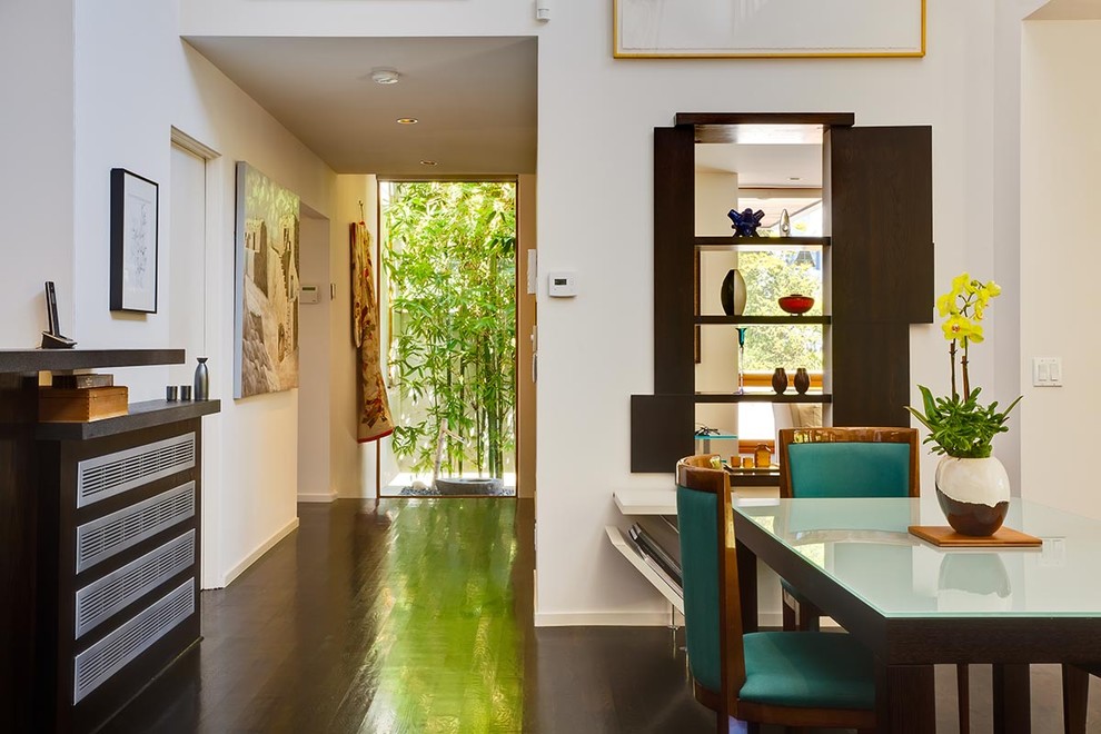 Photo of a world-inspired dining room in Los Angeles with white walls.