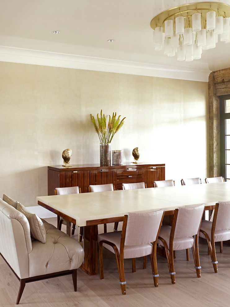 This is an example of a nautical dining room in New York with beige walls and medium hardwood flooring.