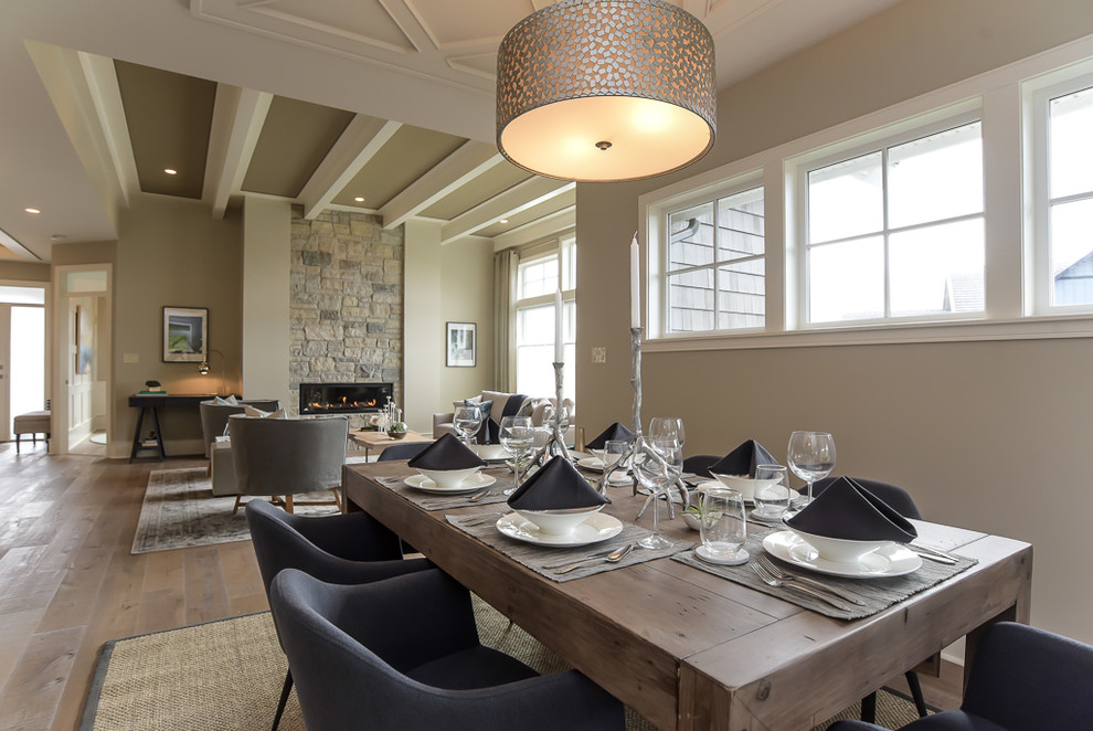 Inspiration for a traditional dining room in Vancouver with beige walls and light hardwood flooring.